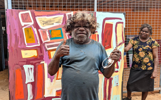 Bob Gibson standing in front of one of his paintings