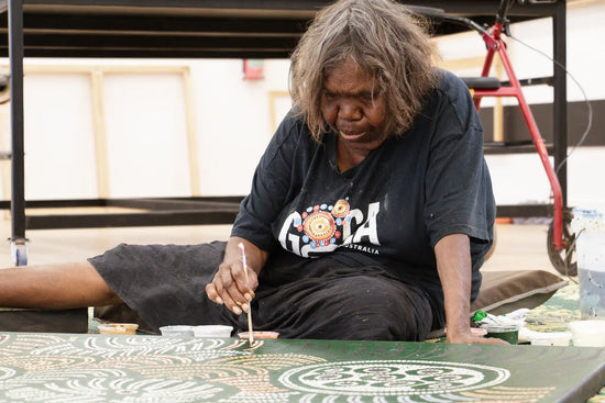 Fiona Young painting at the Tjukurla Art Centre