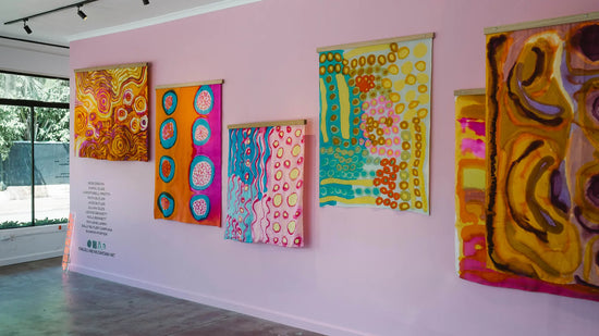 Paintings on silk hanging on a gallery wall