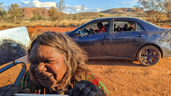 Mary Gibson leaning into view, smiling