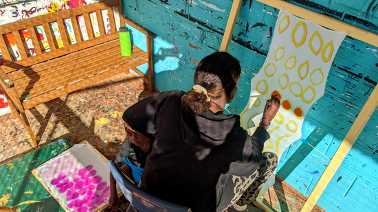 Jade Butler painting on silks at the Tjukurla studio