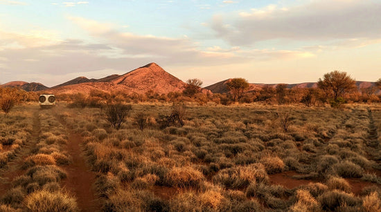 A Landcruiser in the disatance among the desert landscape